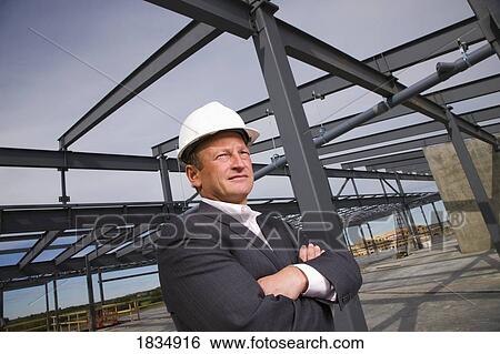 Stock Photograph - Businessman in front of building. Fotosearch