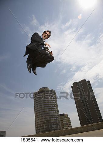 Stock Image - Businessman jumping for joy. Fotosearch