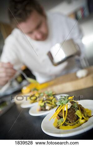 Chef preparing food View Large Photo Image Stock Photo - Chef preparing food. Fotosearch