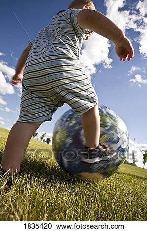 Child playing with ball View Large Photo Image Stock Image - Child playing with ball. Fotosearch