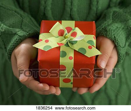 Child's hands holding a present View Large Photo Image Picture - Child's hands holding a present. Fotosearch