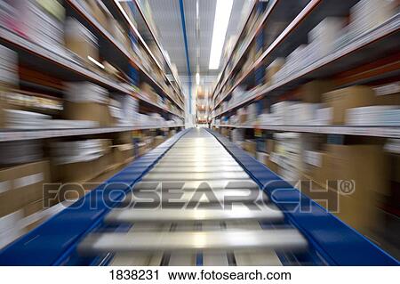 Stock Image - Conveyor belt moving in a warehouse. Fotosearch