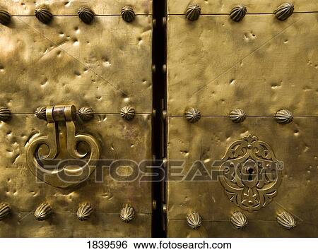 Cordoba, Spain; Door knocker and keyhole on copper door of La Mezquita, The Great Mosque View Large Photo Image Stock Photograph - Cordoba, Spain; Door knocker and keyhole on copper door of La Mezquita, The Great Mosque. Fotosearch
