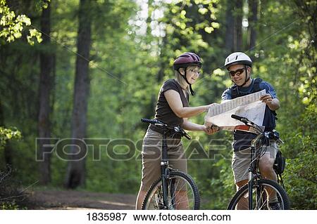 Couple biking View Large Photo Image Stock Photo - Couple biking. Fotosearch