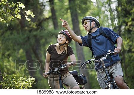 Stock Photo - Couple biking. Fotosearch
