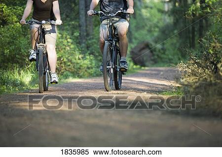 Couple biking View Large Photo Image Stock Photography - Couple biking. Fotosearch