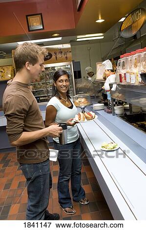 Couple in cafeteria View Large Photo Image Stock Photo - Couple in cafeteria. Fotosearch