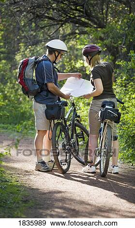 Couple looking at a map View Large Photo Image Stock Photo - Couple looking at a map. Fotosearch