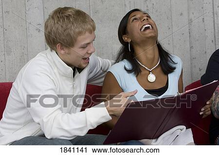 Couple looking at photo album View Large Photo Image Stock Image - Couple looking at photo album. Fotosearch