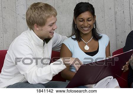 Couple looking at photo album View Large Photo Image Stock Image - Couple looking at photo album. Fotosearch