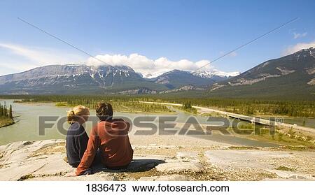 Couple sitting overlooking river View Large Photo Image Stock Image - Couple sitting overlooking river. Fotosearch