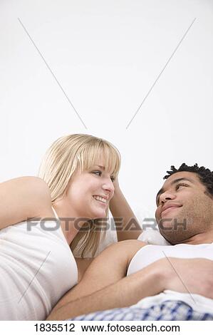 Couple smiling at each other View Large Photo Image Stock Image - Couple smiling at each other. Fotosearch