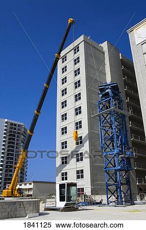 Crane assembly outside new hotel, Daytona Beach, Florida, USA View Large Photo Image Stock Photography - Crane assembly outside new hotel, Daytona Beach, Florida, USA . Fotosearch