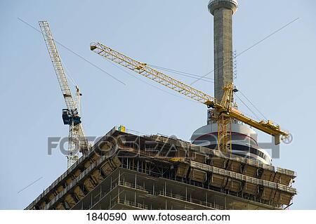 Cranes on a building View Large Photo Image Stock Image - Cranes on a building. Fotosearch