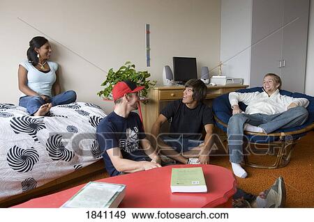 Stock Photo - Friends relaxing in dorm room. Fotosearch