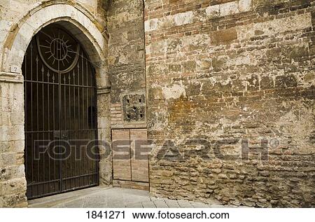 Stock Image - Gated stone wall, Siena, Tuscany, Italy. Fotosearch