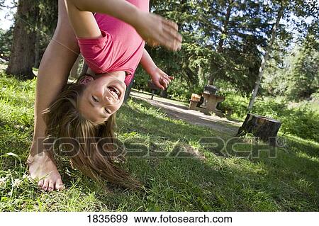 Stock Photo - Girl doing a flip. Fotosearch
