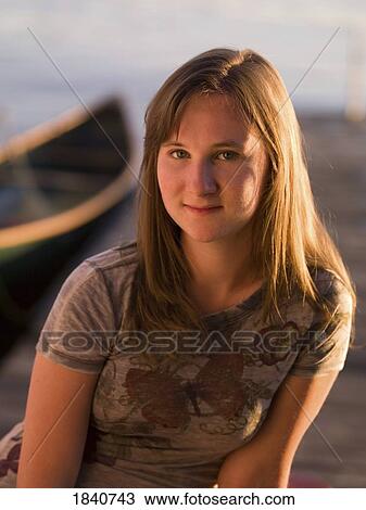 Girl sitting on a dock, Lake of the Woods, Ontario, Canada View Large Photo Image Stock Image - Girl sitting on a dock, Lake of the Woods, Ontario, Canada. Fotosearch