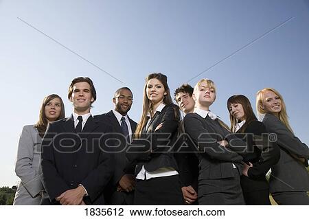 Stock Image - Group of businessmen and businesswomen. Fotosearch