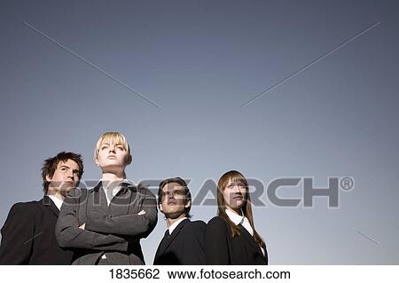 Stock Image - Group of businessmen and businesswomen. Fotosearch