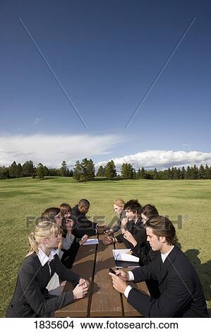 Picture - Group of businesspeople at a table. Fotosearch