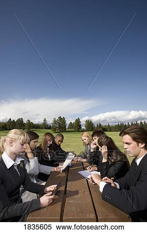Stock Photography - Group of businesspeople at a table. Fotosearch