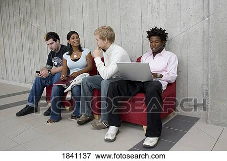 Group sitting on sofa View Large Photo Image Stock Photo - Group sitting on sofa. Fotosearch