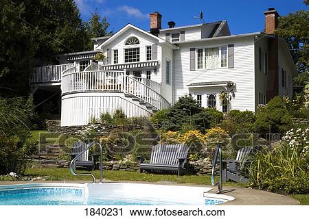 Stock Image - House and swimming pool. Fotosearch