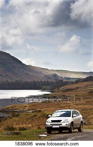 Stock Photograph - Lake District, Cumbria, England; car on the side of the road. Fotosearch
