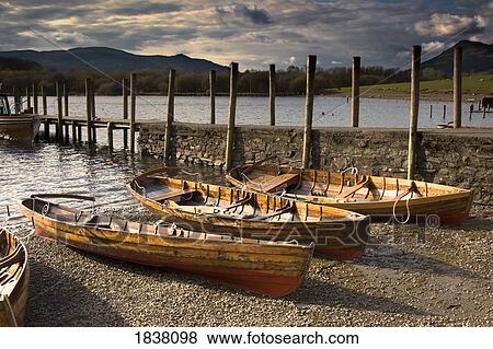 Stock Photo - Lake District, Cumbria, England; four rowboats on shore. Fotosearch