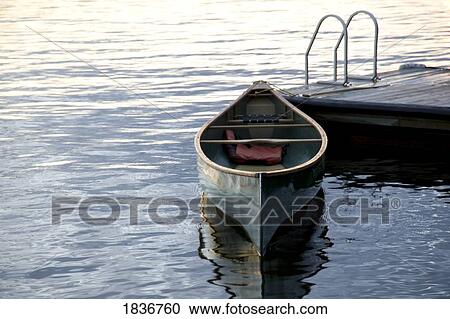 Stock Image - Lake of the Woods, Ontario, Canada; Canoe and dock. Fotosearch