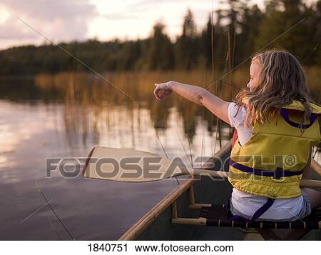 Stock Image - Lake of the Woods, Ontario, Canada; girl in a canoe . Fotosearch