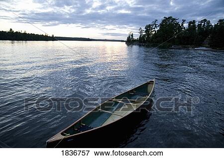Lake of the Woods, Ontario, Canada; Canoe in the water View Large Photo Image Stock Photo - Lake of the Woods, Ontario, Canada; Canoe in the water. Fotosearch