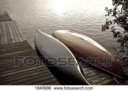 Stock Photograph - Lake of the Woods, Ontario, Canada; canoes on a dock . Fotosearch