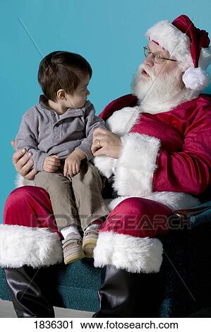 Stock Image - Little boy on Santa's lap. Fotosearch