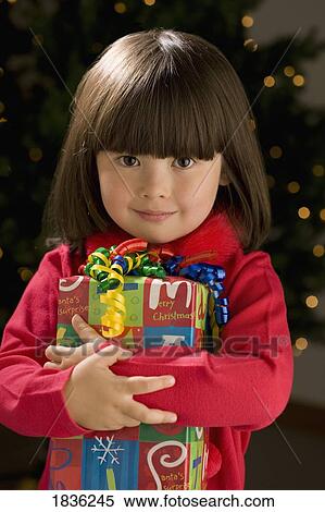 Little girl holding present View Large Photo Image Stock Photography - Little girl holding present. Fotosearch