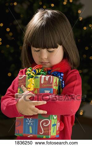 Little girl with present View Large Photo Image Stock Image - Little girl with present. Fotosearch