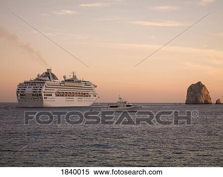 Stock Photography - Los Cabos, Mexico; Cruise ship and boat on water. Fotosearch