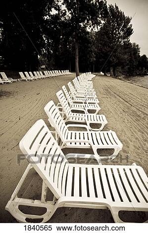 Lounge chairs on a beach, Muskoka, Ontario View Large Photo Image Stock Photography - Lounge chairs on a beach, Muskoka, Ontario. Fotosearch