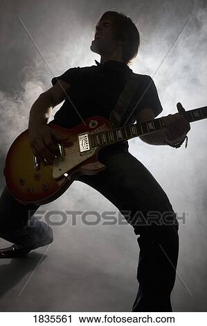 Stock Image - Man playing guitar. Fotosearch
