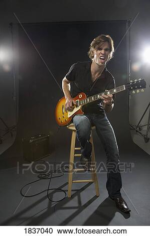 Stock Image - Man playing the guitar. Fotosearch