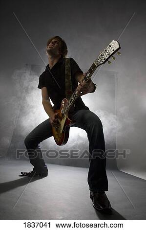 Man playing the guitar View Large Photo Image Stock Image - Man playing the guitar. Fotosearch