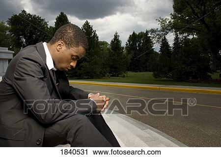 Stock Image - Man sitting on steps. Fotosearch