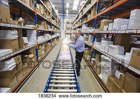 Man working in a warehouse View Large Photo Image Picture - Man working in a warehouse. Fotosearch