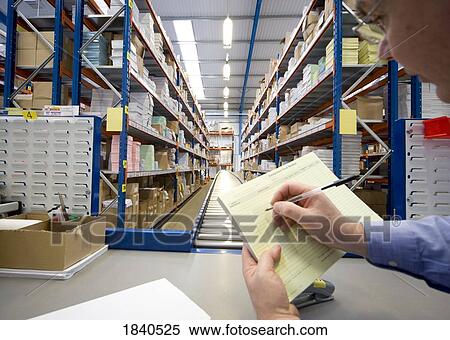 Stock Photography - Man working in warehouse. Fotosearch