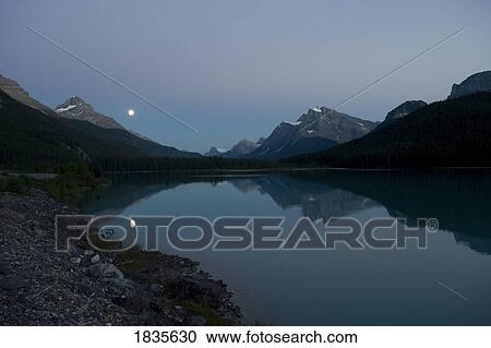 Stock Image - Moonrise over lower Waterfowll Lake, Banff . Fotosearch