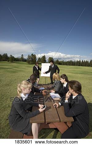 Stock Image - Outdoor business meeting. Fotosearch