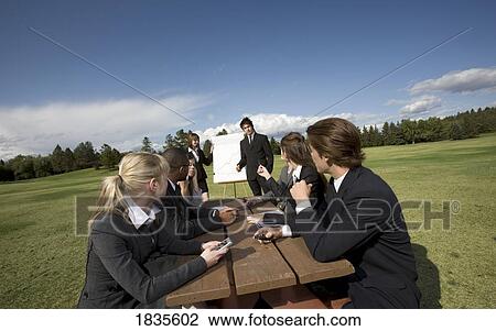 Stock Image - Outdoor business meeting. Fotosearch