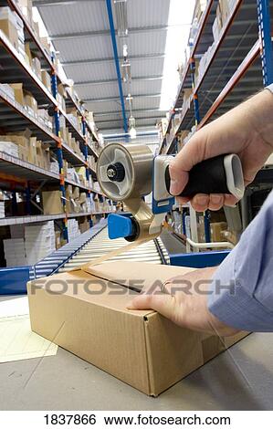 Packaging a box View Large Photo Image Stock Photograph - Packaging a box. Fotosearch