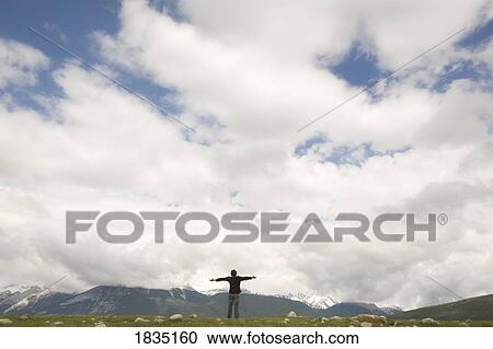 person on an hill with arms outstretched View Large Photo Image Stock Image - person on an hill with arms outstretched. Fotosearch